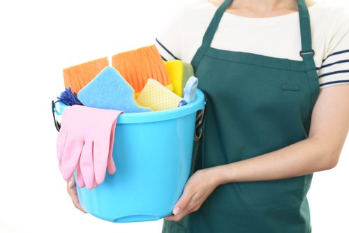 A cleaner preparing a guest-ready kitchen and living area in Edgware